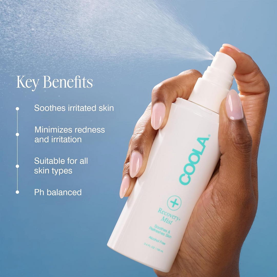 Hand holding COOLA Recovery+ Mist product with key benefits listed on a blue background