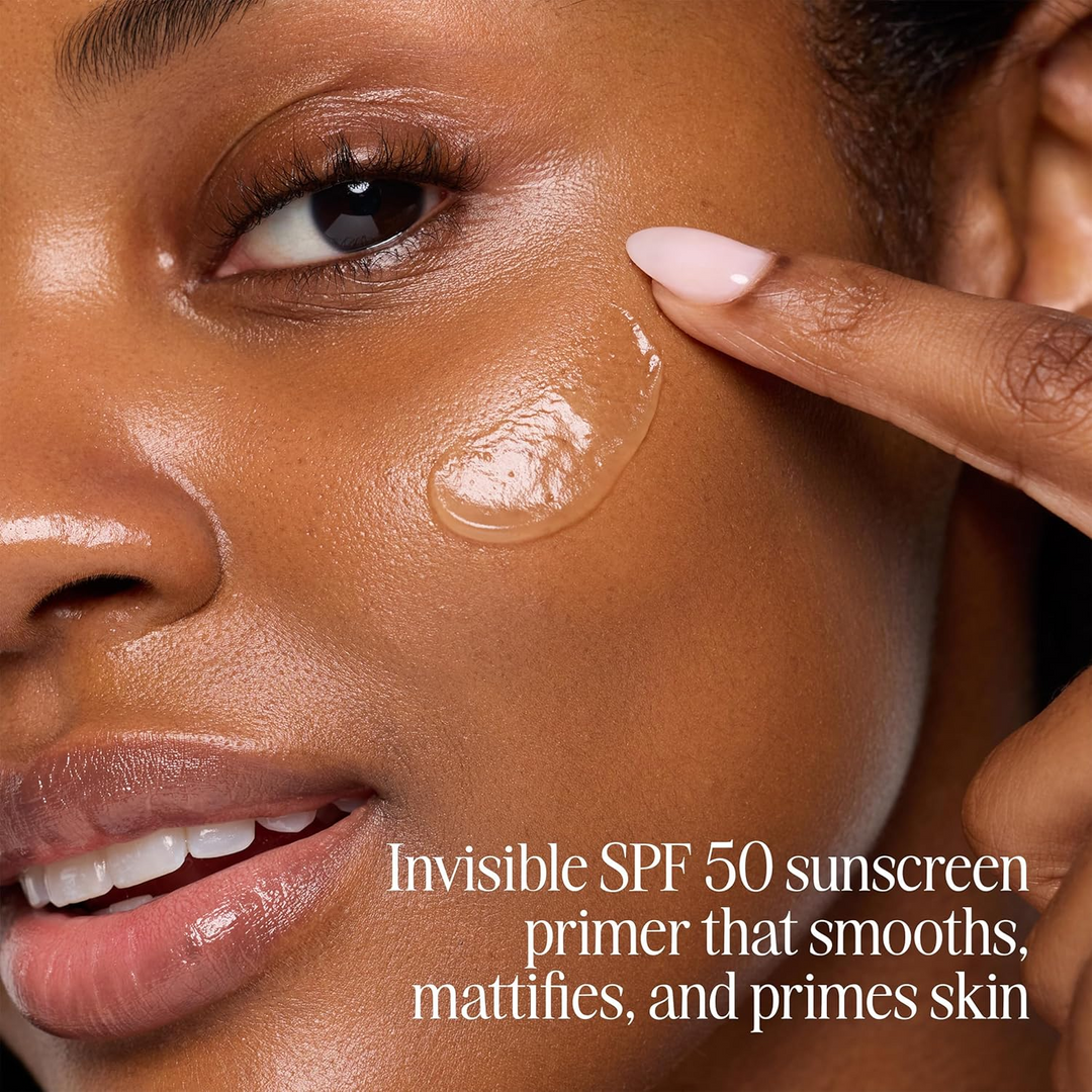 Woman applying COOLA SunBlur Primer SPF 50 sunscreen primer on her face