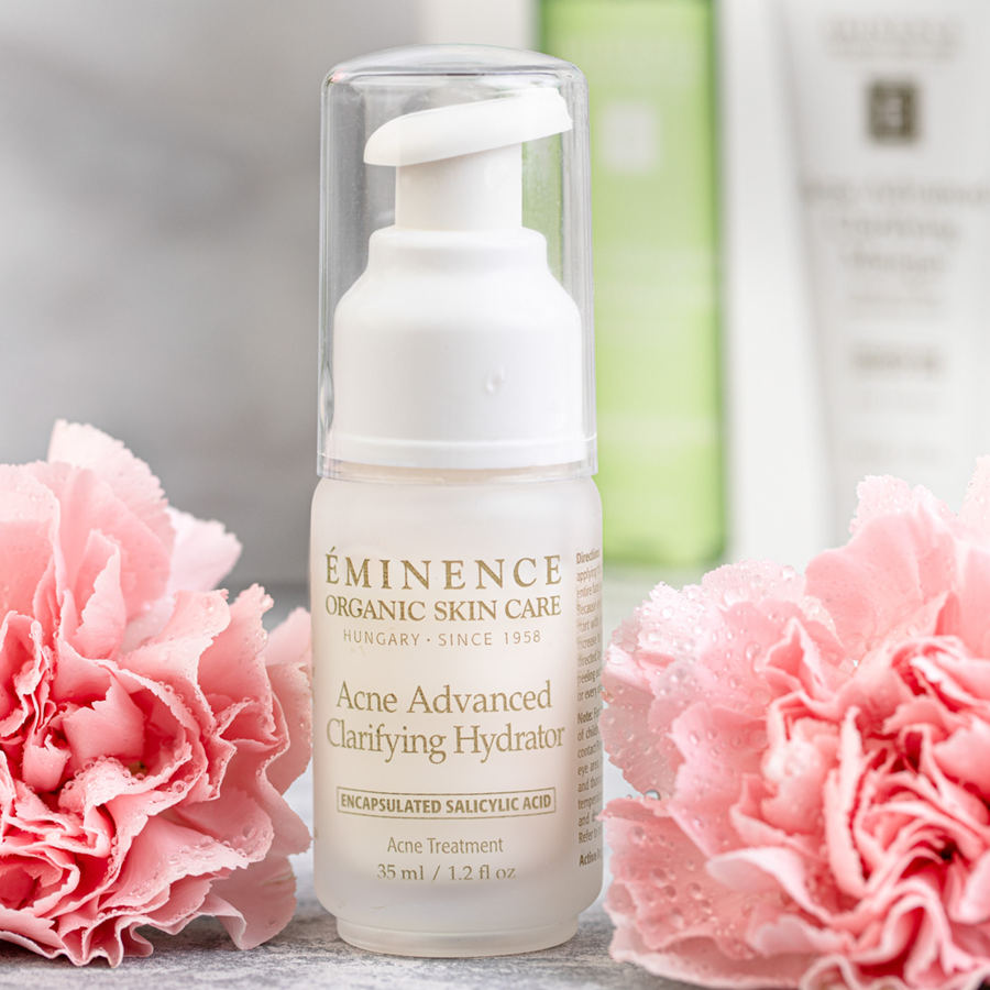 Eminence Organics Acne Advanced Clarifying Hydrator lifestyle with flowers