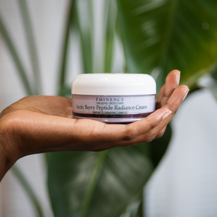 hand holding Eminence Organics Arctic Berry Peptide Radiance Cream