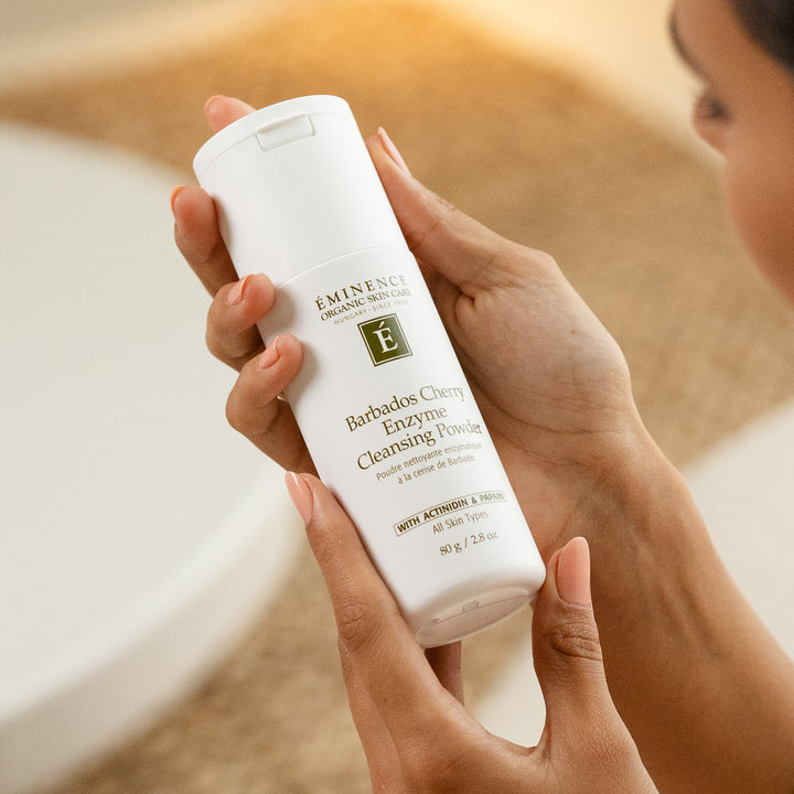 Woman holding Eminence Organics Barbados Cherry Enzyme Cleansing Powder