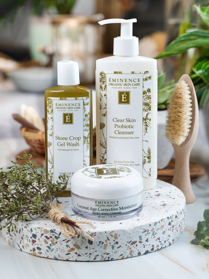 Eminence skincare products on a decorative stone tray with plants in the background