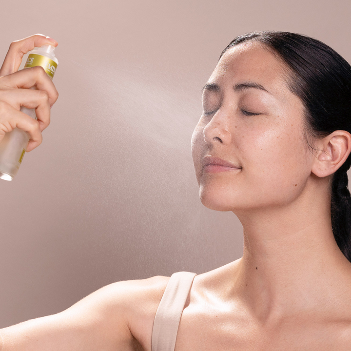 Person applying Eminence Organics Hawthorn Tonique to their face with a neutral background