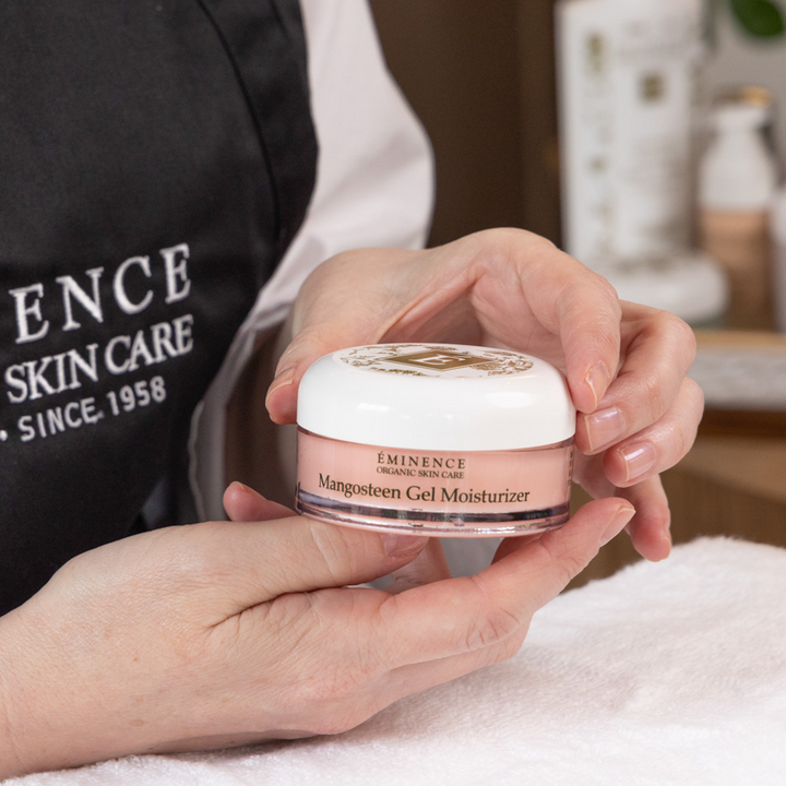 woman holding Eminence Organics Mangosteen Gel Moisturizer in her hands