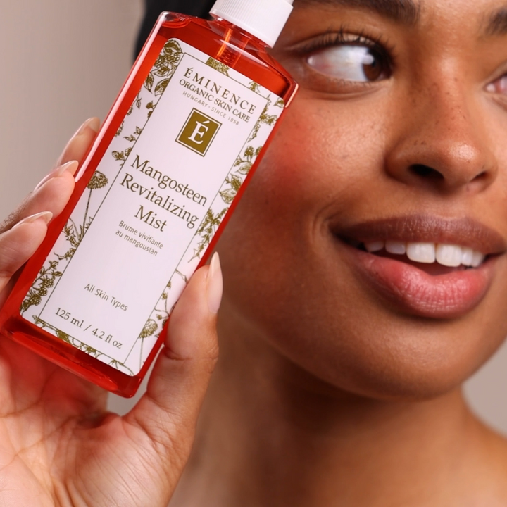 woman holding Eminence Organics Mangosteen Revitalizing Mist