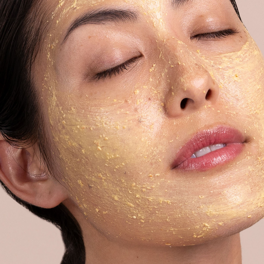 woman using Eminence Organics Seabuckthorn Balancing Masque on her face