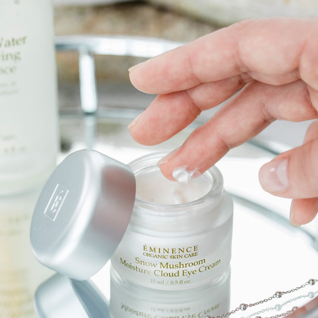 hand and finger touching Eminence Organics Snow Mushroom Moisture Cloud Eye Cream
