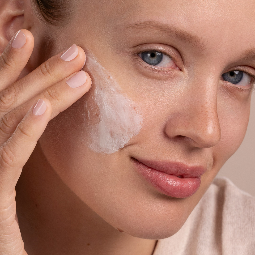 woman applying Eminence Organics Snow Mushroom &amp; Reishi Masque on her face