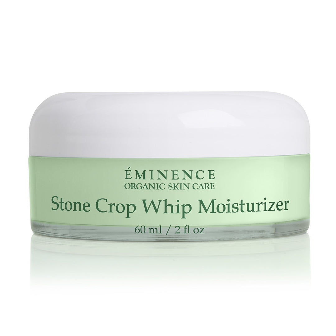 A jar of Éminence Organic Skin Care Stone Crop Whip Moisturizer, 60 ml / 2 fl oz, featuring a light green label and a white lid, set against a clean white background with a soft reflection.