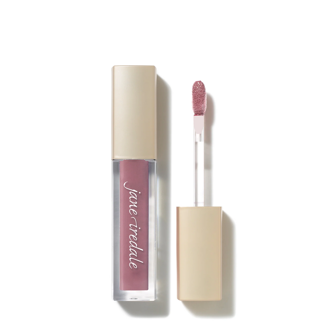 A tube of Jane Iredale ColorLuxe High Impact Lip Glaze dusk in a dusty rose pink shade, shown next to its applicator wand with a glittery pink tip, on a clean white background.