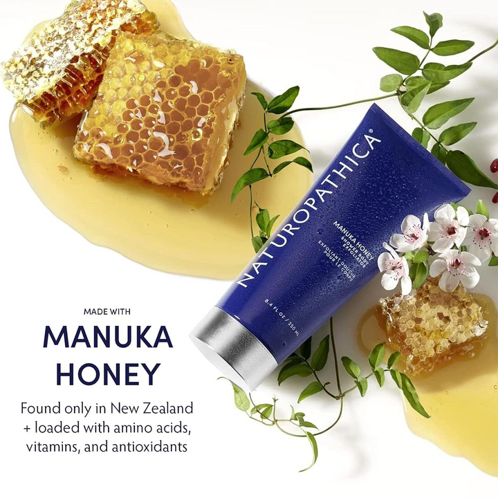 Naturopathica Manuka Honey Shower Body Exfoliator with manuka honeycomb and flowers on a white background