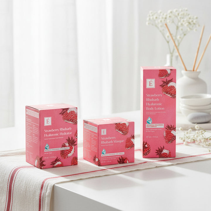 Pink skincare Eminence Organics Strawberry Rhubarb Trio - Limited Edition boxes with strawberry design on a white surface.