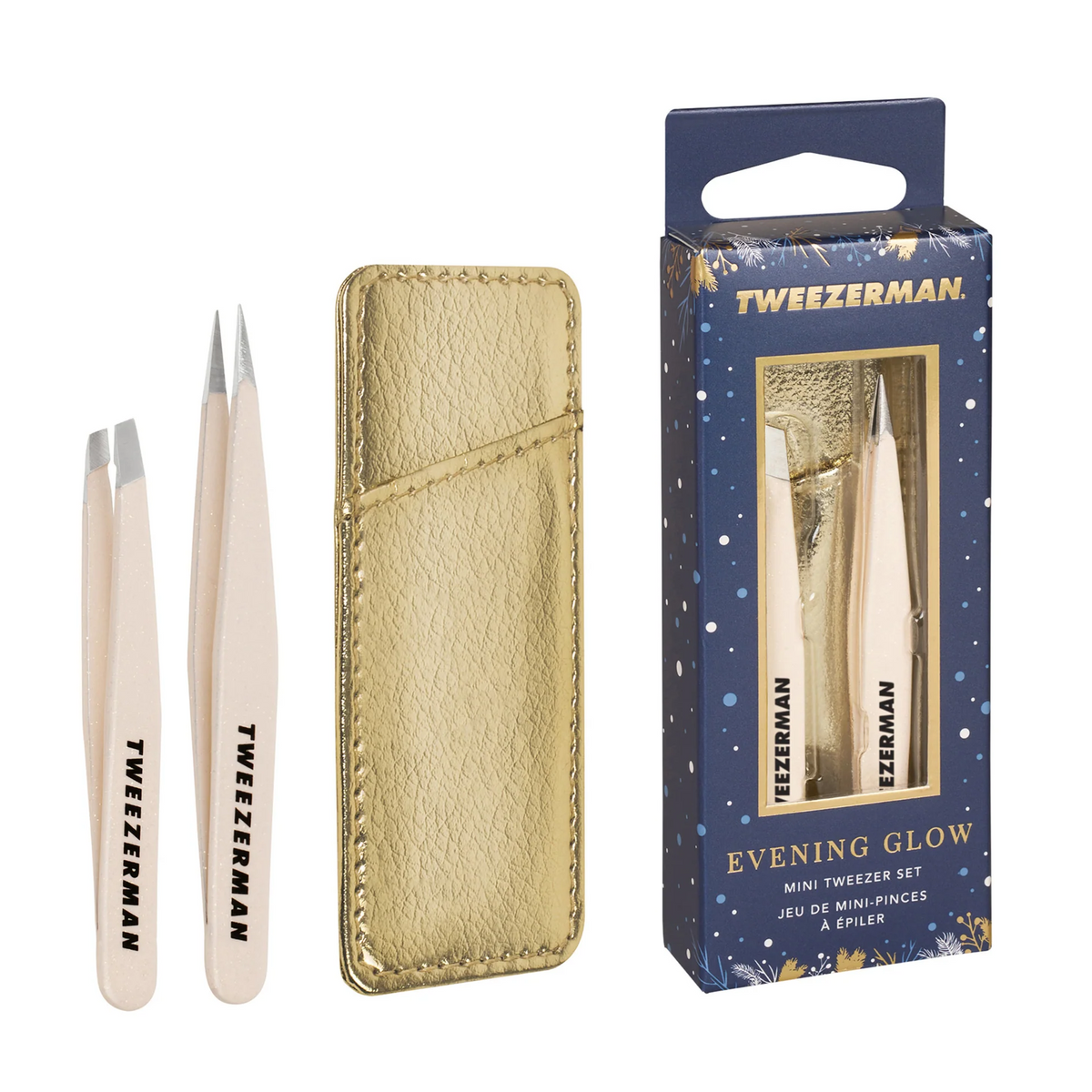 Tweezerman Evening Glow mini slant and point tweezers in cream with a gold-tone case and navy gift packaging.
