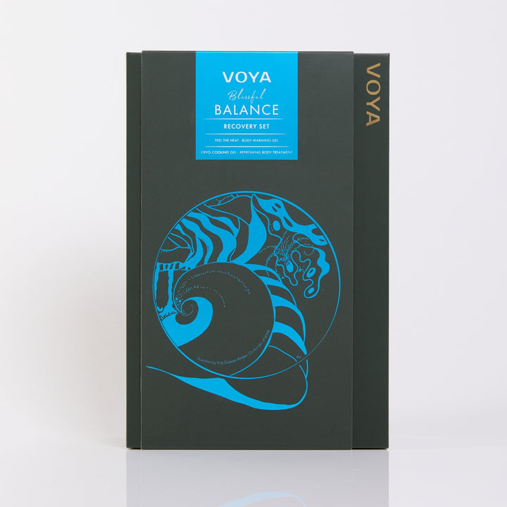 VOYA Blissful Balance gift box featuring a bright blue spiral shell with coastal illustrations on dark green packaging.