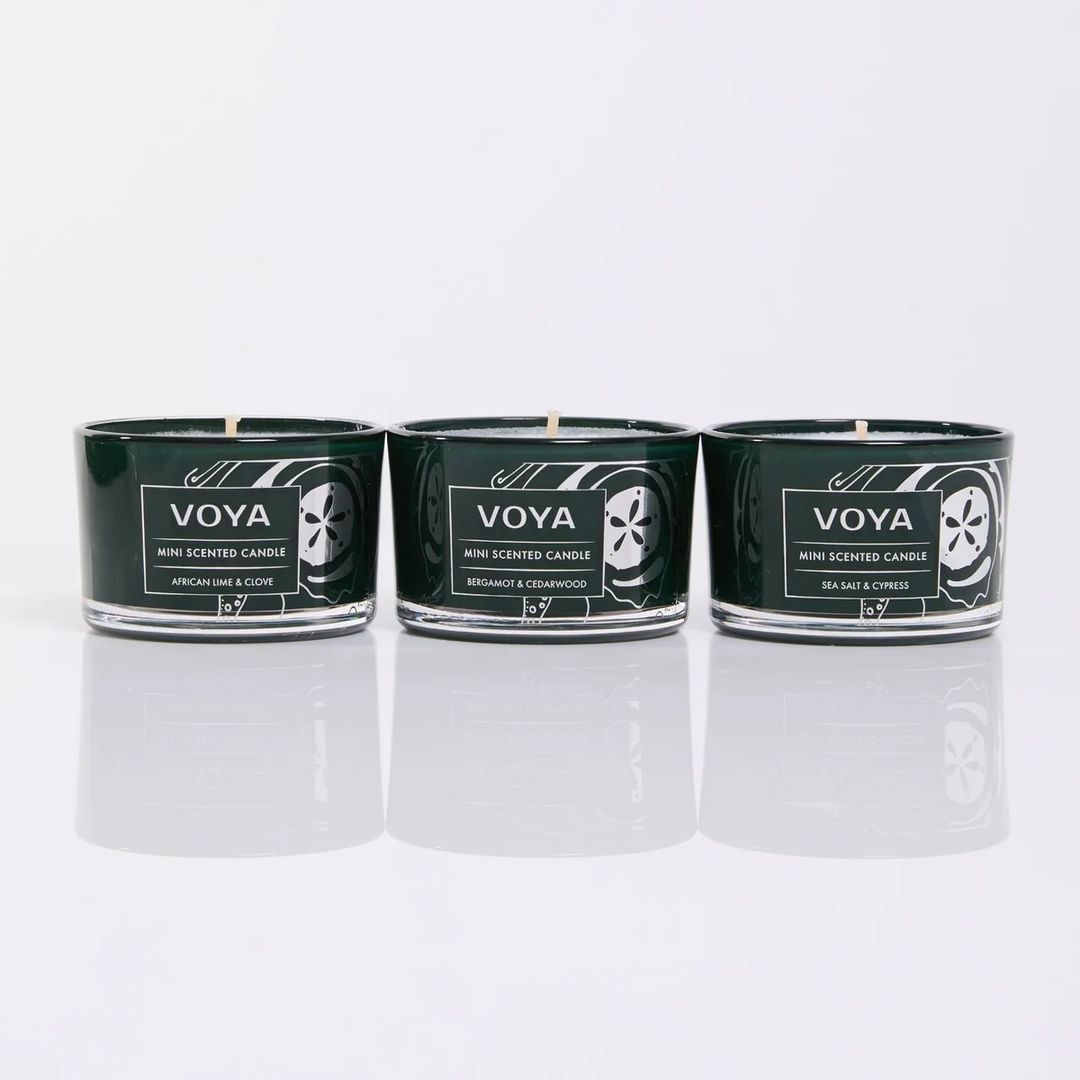 VOYA mini candles in African Lime &amp; Clove, Bergamot &amp; Cedarwood, and Sea Salt &amp; Cypress, displayed side by side.
