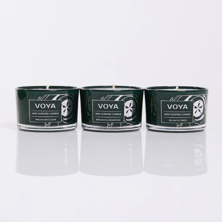VOYA mini candles in African Lime &amp; Clove, Bergamot &amp; Cedarwood, and Sea Salt &amp; Cypress, displayed side by side.
