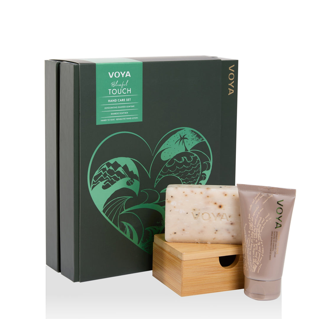 VOYA Blissful Touch Hand Care Set with soap bar, wooden soap box, hand lotion tube and green illustrated gift box.
