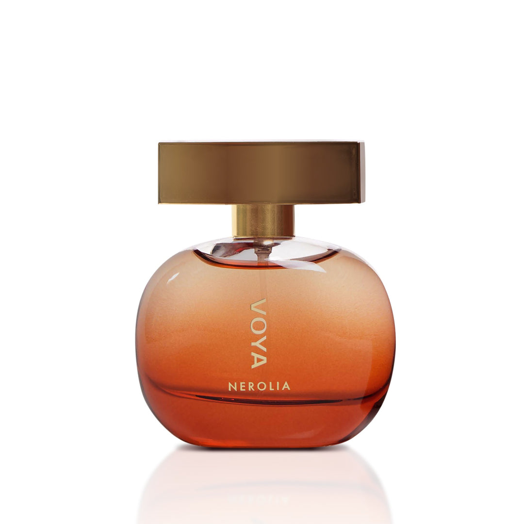 Voya Nerolia perfume bottle with a rounded amber-brown glass body, a gold neck, and a square metallic gold cap, shown on a white background with a soft reflection.