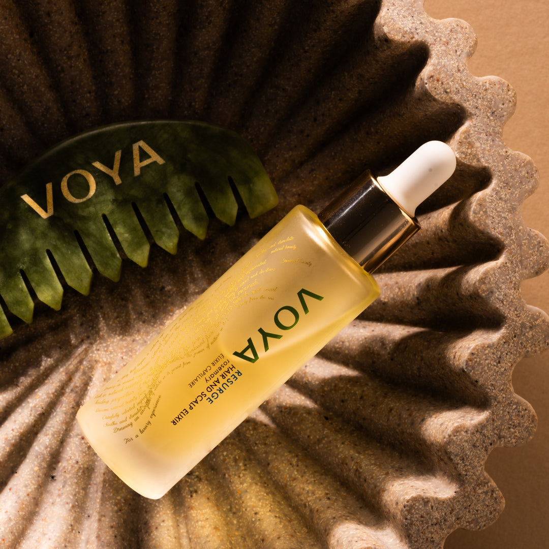 VOYA skincare bottle with dropper on a textured surface