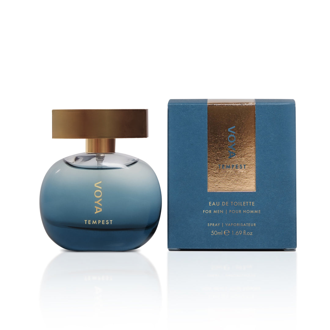 VOYA Tempest Eau de Toilette for men, featuring a blue gradient spherical bottle with a gold cap next to its blue packaging box with a metallic gold label.