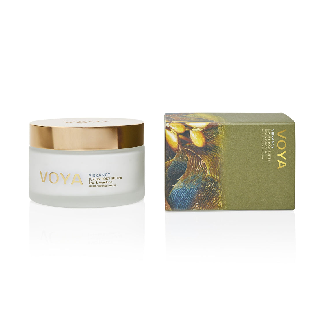 VOYA Vibrancy Luxury Body Butter jar with a gold lid beside its green presentation box.